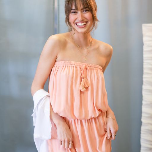 what the koy staff team are wearing over labour day. Model wearing blush pink miami bandeau sleeveless mini dress from Koy Resort Summer 2022 resort wear collection