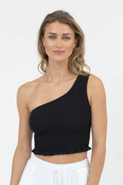 Woman wearing a black one-shoulder top against a white background