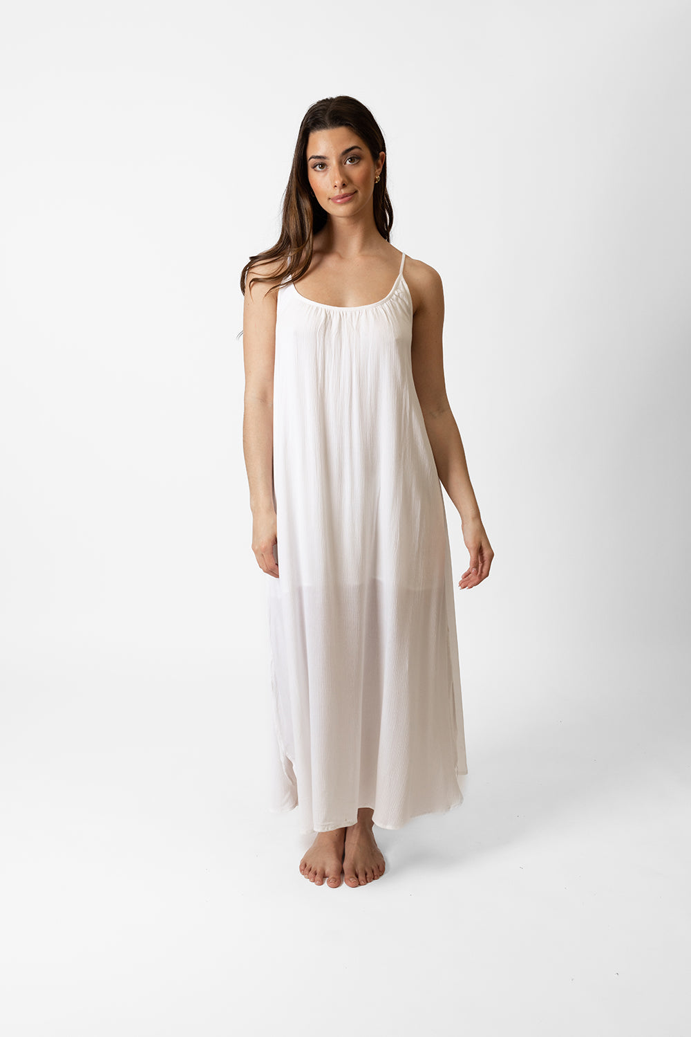 brunette hair woman model wearing a white spaghetti strap flowy oversized midi dress