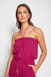 Woman wearing a pink strapless dress against a white background