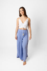 Brunette model facing front, wearing Bahama Blue Miami Split Leg Beach Pants made from crinkle rayon with an elastic waistband, high side slits, and rounded hem. Flowy yet true to size, perfect for a stylish and comfortable summer look. Koy Resort affordable vacation, cruise, and resort-wear.