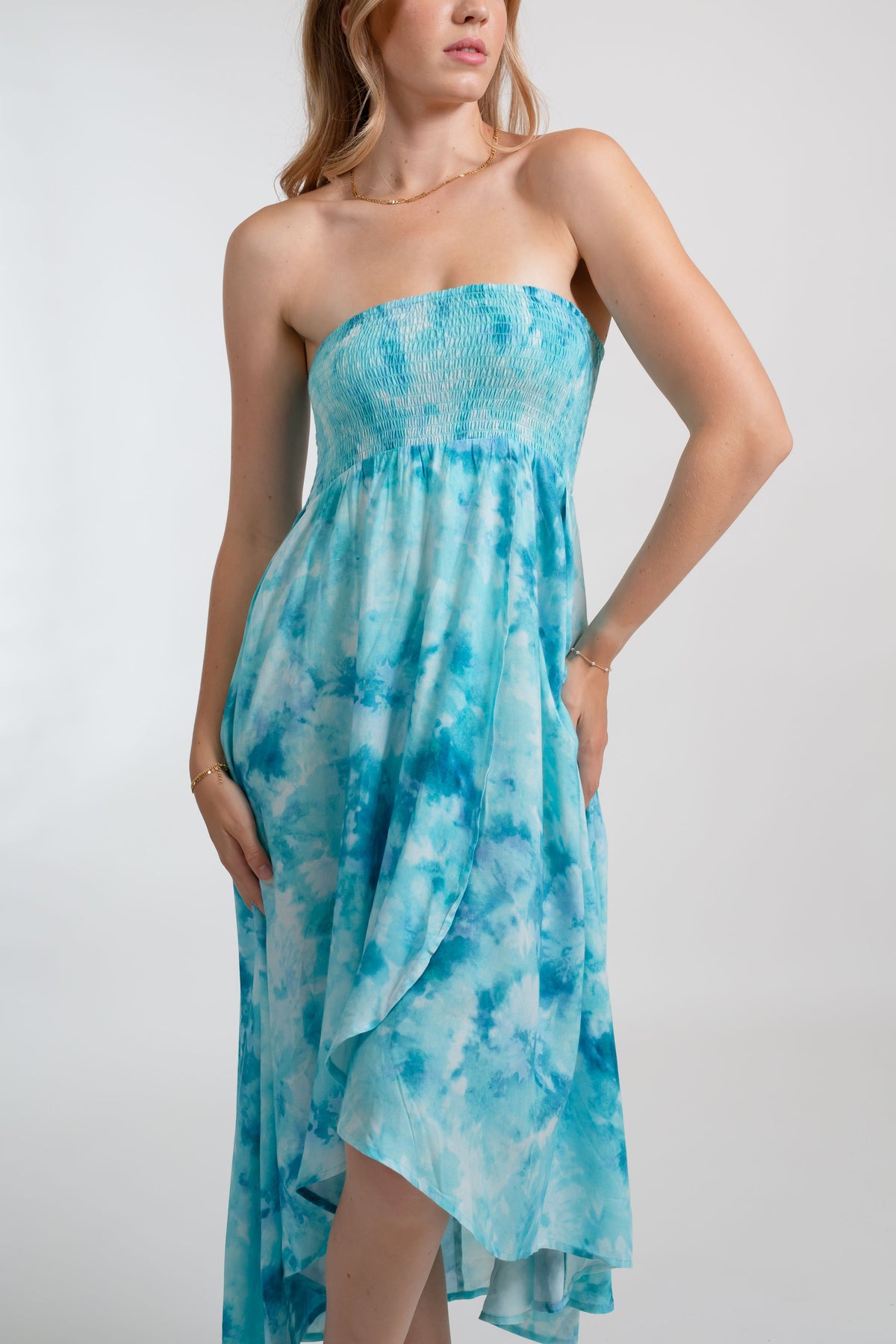 a woman wearing a blue tie-dye bandeau dress which also works as a beach cover up