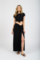 Blonde model wearing black laguna side knot maxi slit skirt facing front. Paired with Laguna knot top in black from Koy Resort. Koy Resort vacation cruise wear.