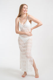 Koy Resort vacation, resort and beachwear. Model facing front wearing white cream lace flamenco cover up midi dress with adjustable spaghetti straps and slits